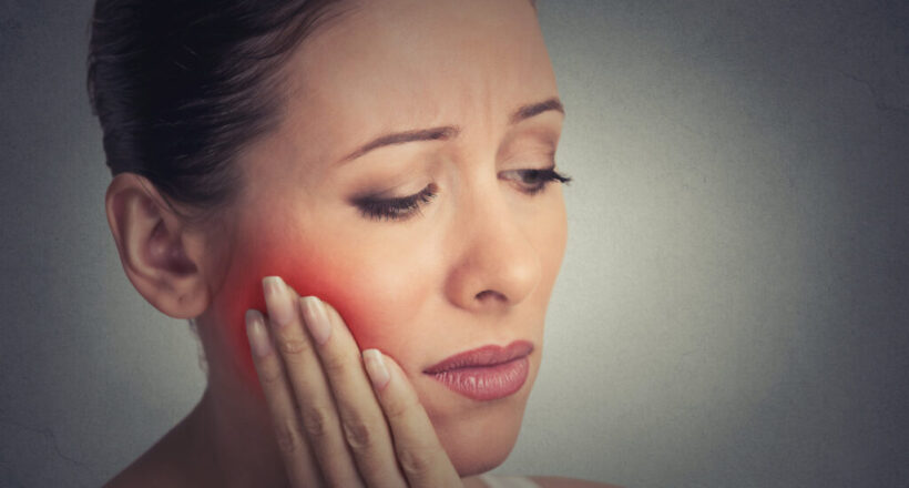 woman with sensitive tooth ache crown problem about to cry from pain